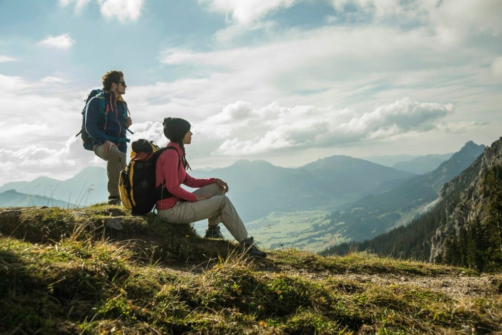 Austria, Tyrol, Tannheimer Tal, young couple resting on hiking tour